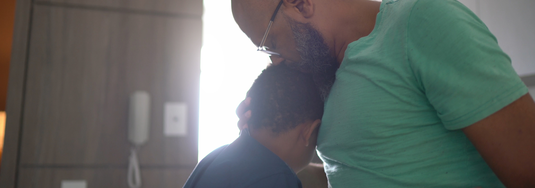 A father comforts his tween son